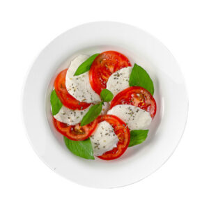 Mozzarella With Tomatoes And Basil On White